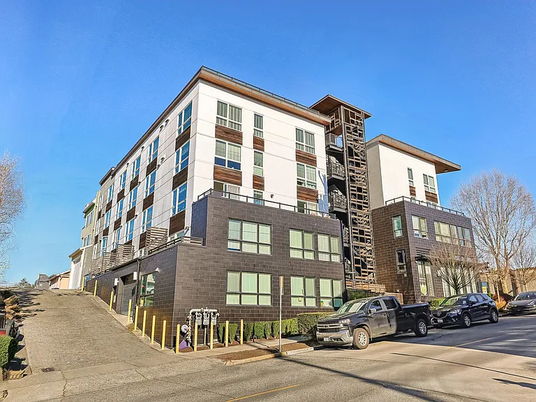 Discover modern urban living at 4400 Alaska in Seattle, WA. This stunning apartment building exterior showcases contemporary design and convenient street acc...