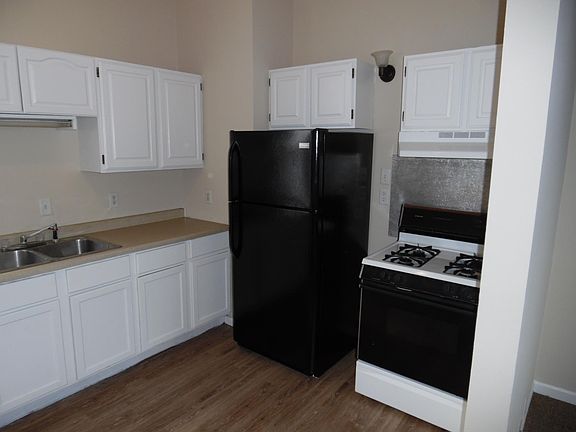 Kitchen has refrigerator an gas range/oven