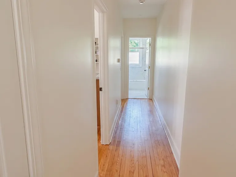 From living area, looking down hallway. Bathroom at the end, and bedrooms one and two open up to the left.