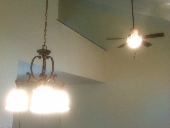 View from living room looking up at oversized master bedroom loft area. Many use loft corner of bedroom as an office.
