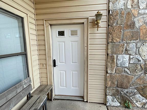 Welcoming entrance with a bench