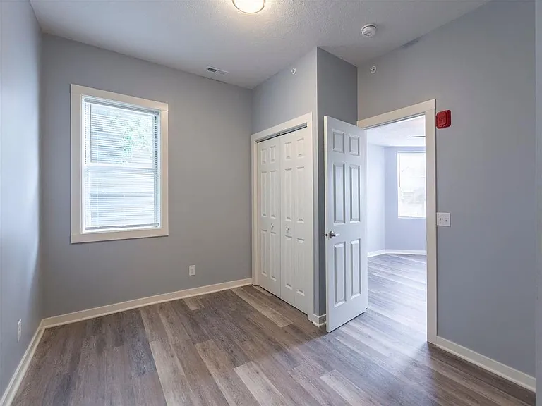 Bedroom with grey walls and white trim at Park Avenue Apartments.