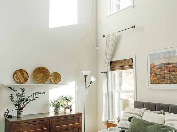 Two-story primary bedroom with plenty of light