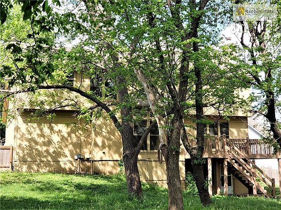 Back of home with large deck and walk out from finished basement.