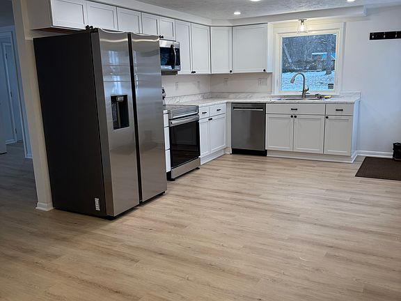 looking at kitchen from eat-in area. Entrance to family room on the left