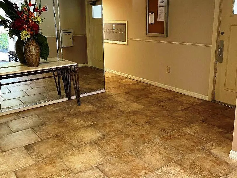 lobby showing corridor to mailboxes and side door.