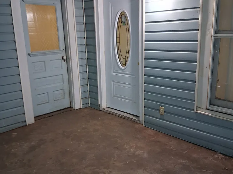 double front doors off the enclosed porch/mud room
