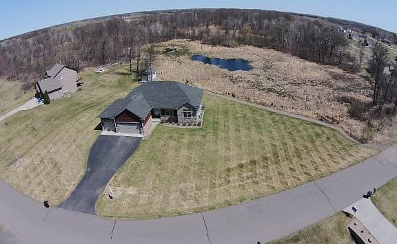 Aerial view of the property, sprinkler system and park like grass.