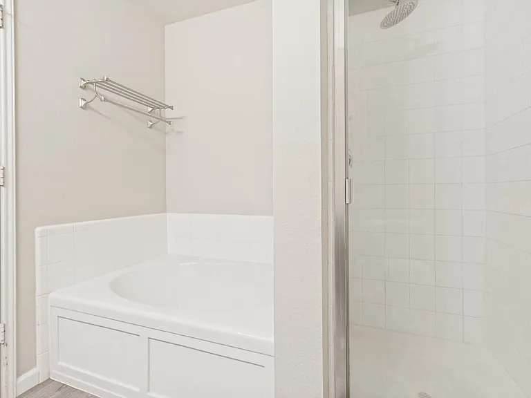 View of soaking tub and glass shower.