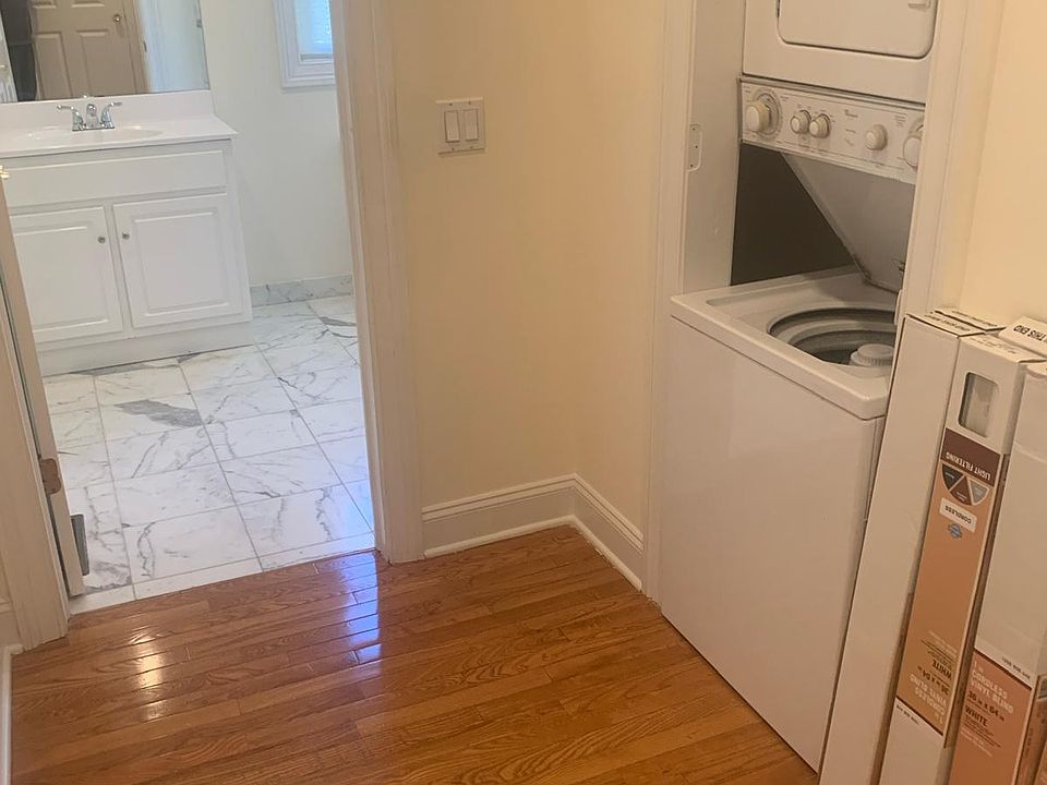 In-Unit Washer Dryer and partial view of the bathroom