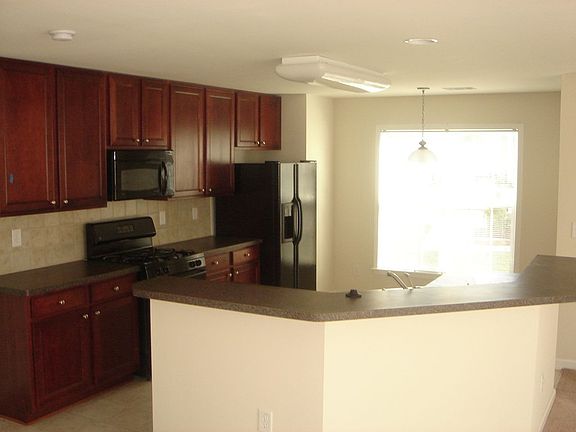 Open , Spacious Kitchen w/ Cherry Cabinets, Upgraded Coordinated Countertops, Black Appliances.... 