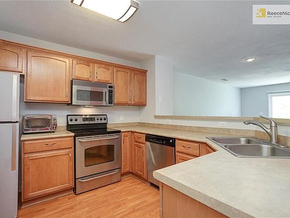 Open Kitchen w/ stainless steel appliances.