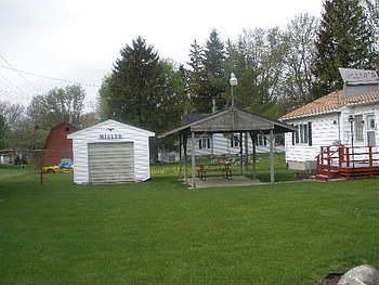 Large and quiet back yard, storage building for that lawn equipment and a covered picnic area for th