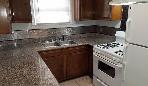Granite countertops, refinished cabinets, range/oven and refrigerator