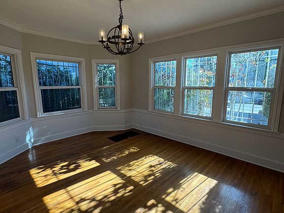 Formal dining room with picture windows and access to kitchen.