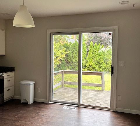 sliders from kitchen to private deck and back yard