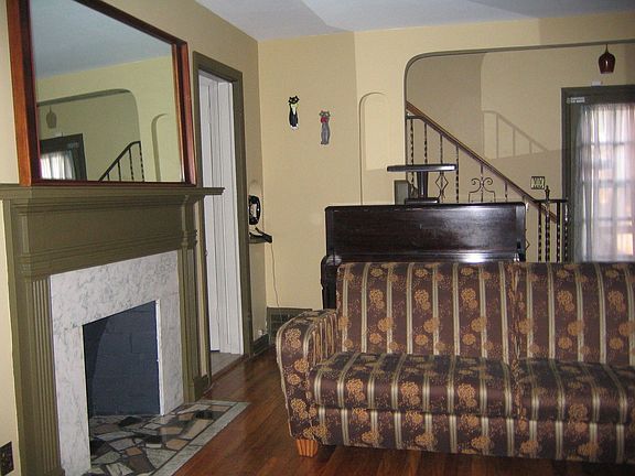 Marble Fireplace / Built-Ins in Hardwood Floor Living Room.  Access to Deck.