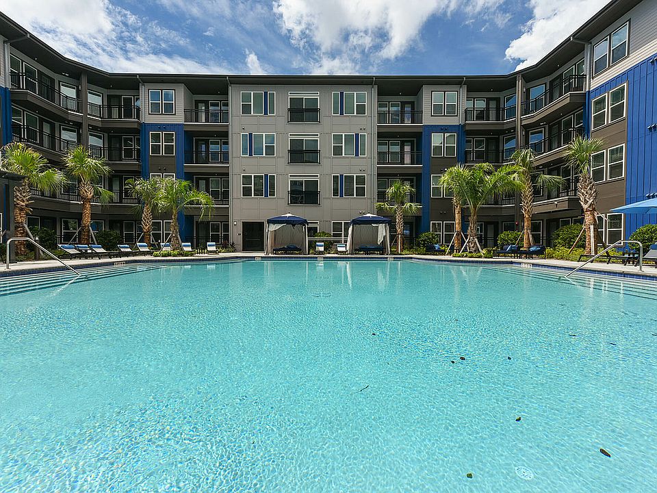 Relax in style at this modern apartment's sparkling pool and lush surroundings.