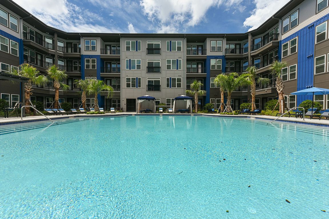 Relax in style at this modern apartment's sparkling pool and lush surroundings.