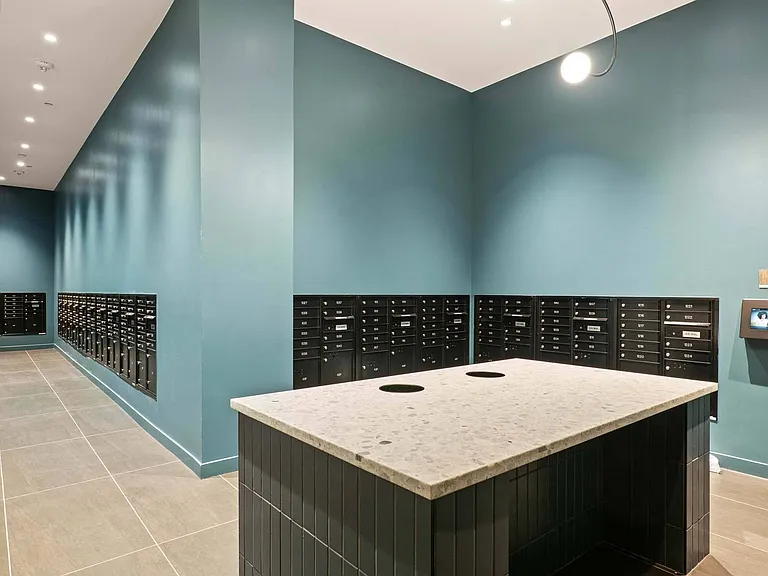 Efficient and organized, the mailroom offers a sleek space for managing deliveries and correspondence.
