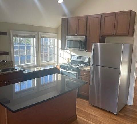 Kitchen includes range, refrigerator, dishwasher, microwave