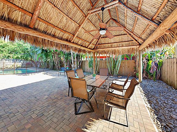 Escape to a tropical island resort with your own tiki hut in the back yard