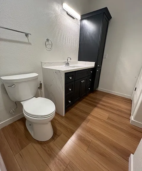 View fron the all new shower into the new bathroom toilet sink and cabintery. Hookjups for washer and dryer in this room to the right