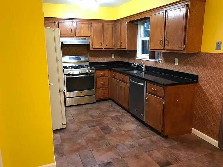 Kitchen with Stainless steel appliances and Granite countertop