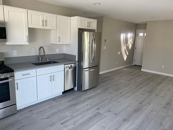 View back to front door, standing in front of sliding doors to balcony.