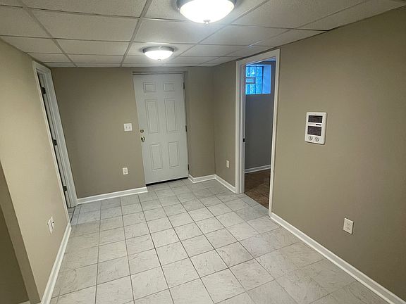 Large living room with tile flooring throughout the entire unit