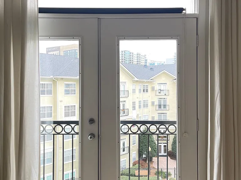 Juliet Balcony overlooking large pool and midtown views