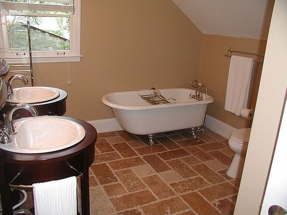 Master Bath with claw foot tub, dual vanities and sep. tile and glass shower