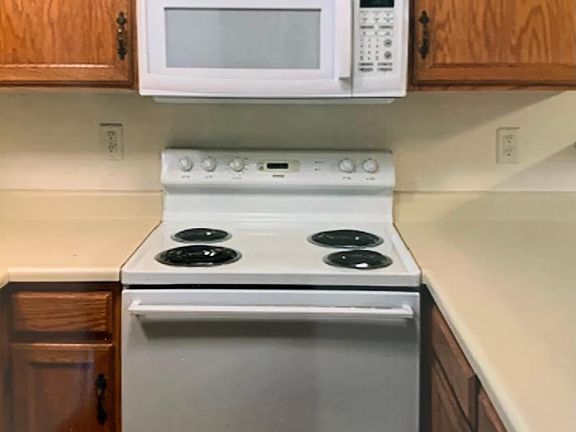 The kitchen has cabinets galore and a bar to place barstools around. All the usual kitchen appliances are in the unit.