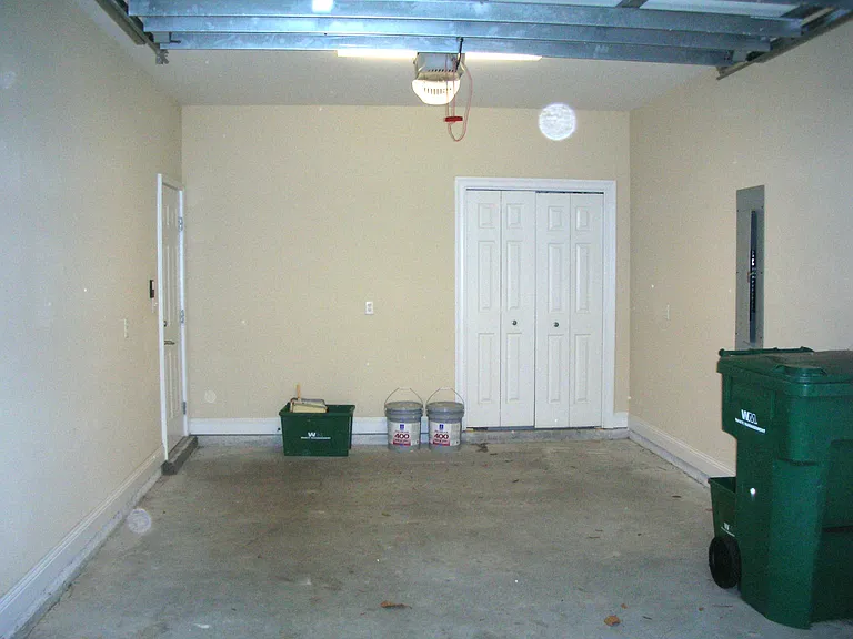 Garage with 8 foot door for tall vehicles and garage door opener. Closet is for HVAC. Door to left goes into house.