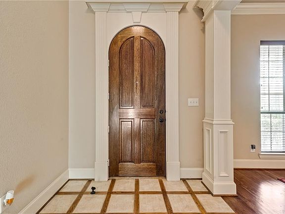 Beautiful foyer with custom wood door and woodwork!