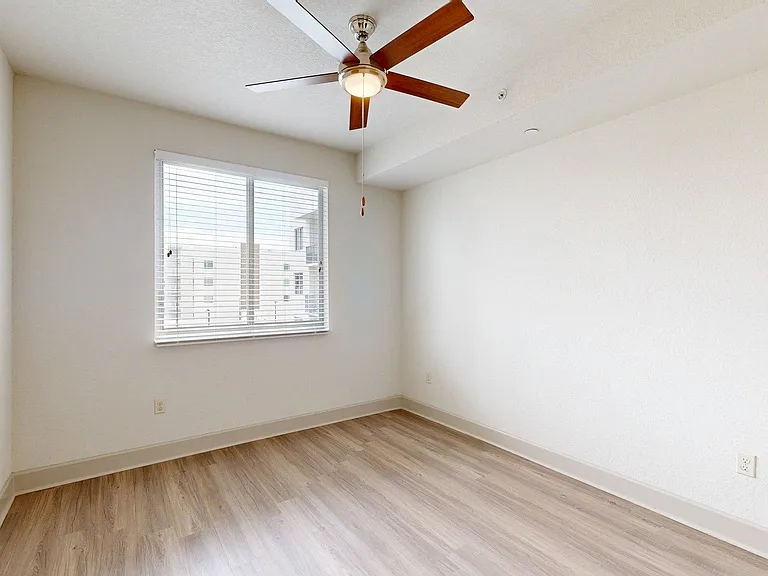 Apartment bedroom with wood style floor.