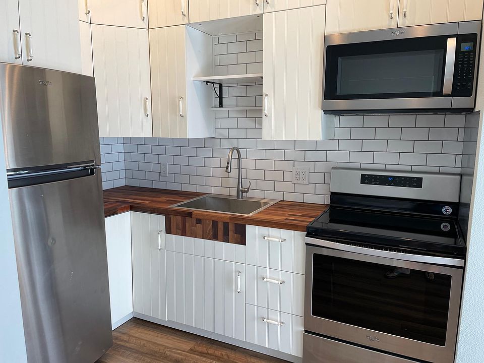 The remodeled farm style kitchen with stainless steel appliances