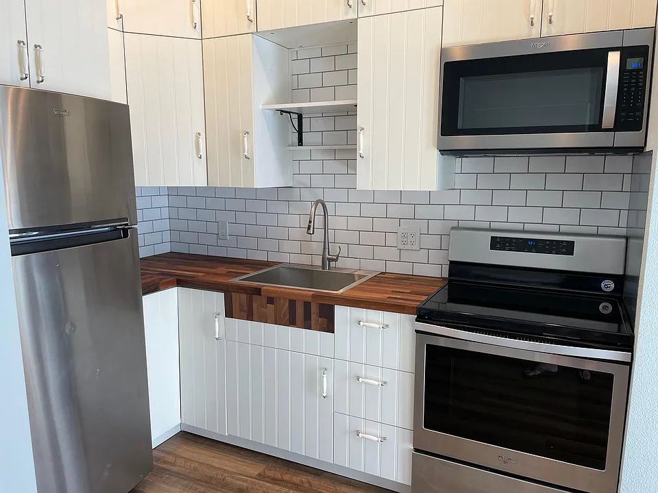 The remodeled farm style kitchen with stainless steel appliances