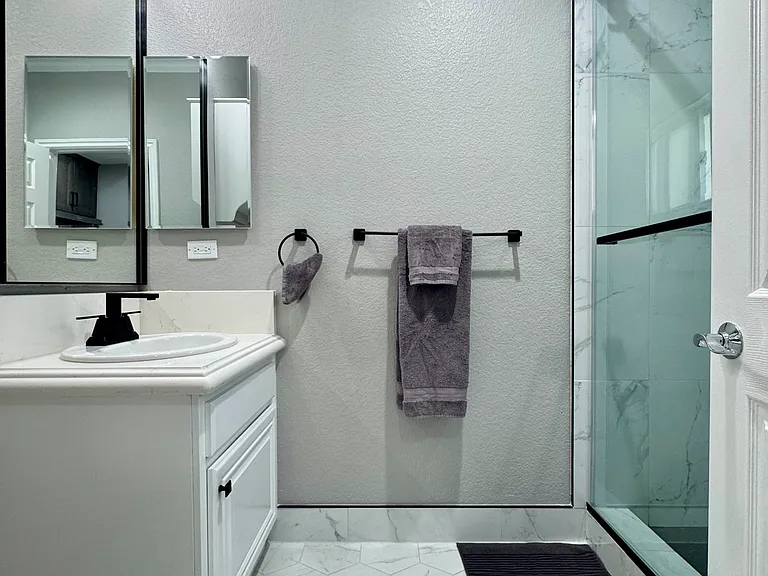 Clean, remodeled bathroom with modern finishes and plenty of storage space.