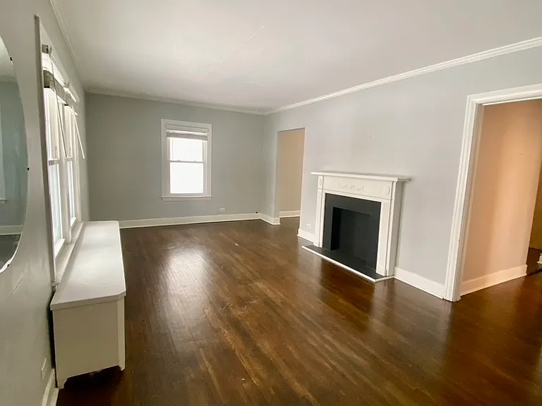 Living room with hardwood floors and decorative fireplace