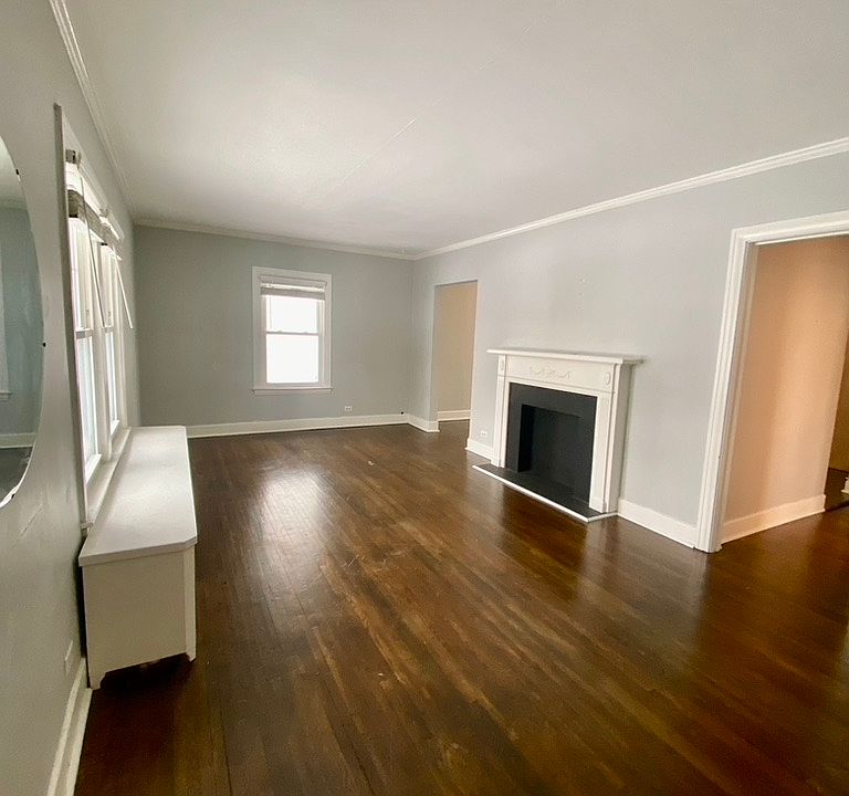 Living room with hardwood floors and decorative fireplace