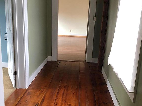 beautiful hardwood floor hallway to bedrooms