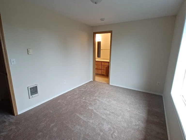 Upstairs bedroom with door to bathroom