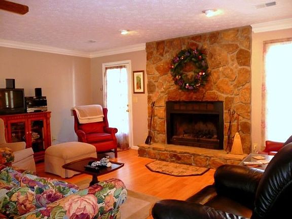 Family room with stone fireplace/hearth.