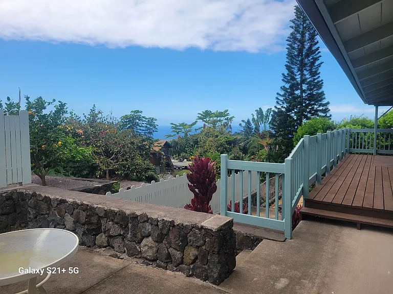 View from the lounge area to the balcony of the living room with sidewalk leading down to bonus room.