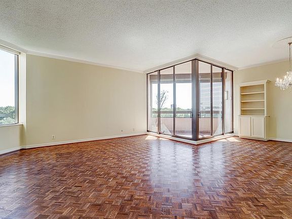 The expansive living area offers great functionality for furniture placement. The cozy balcony overlooks the swimming pool and tennis courts and features storm shutters.