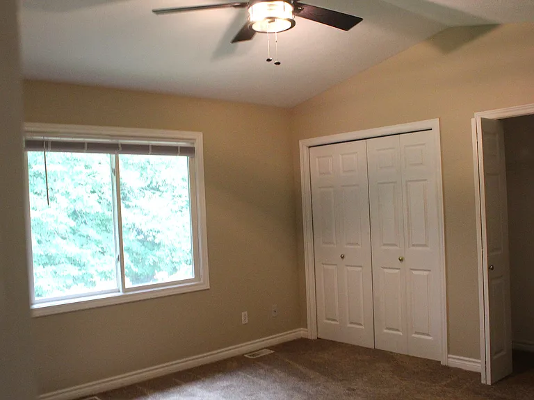 Master bedroom with 2 closets and view of the backyard