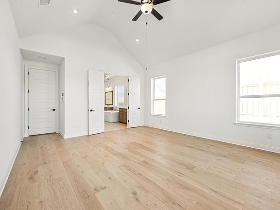 Primary bedroom features a cathedral ceiling