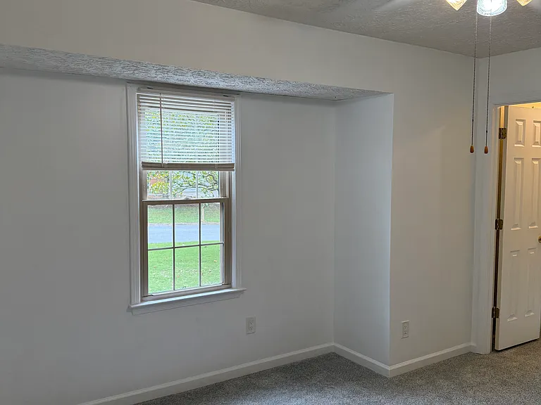 Cool neutral white tones in larger room overlooking the 2 gorgeous magnolia trees in the front yard.