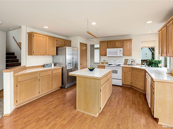 Practical kitchen with island, pantry and ample counter space.